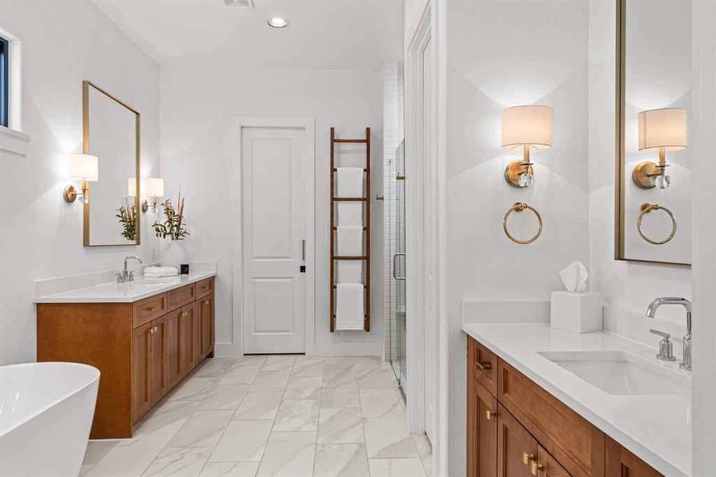 Primary bath wide view — dual vanities, freestanding tub and walk-in shower