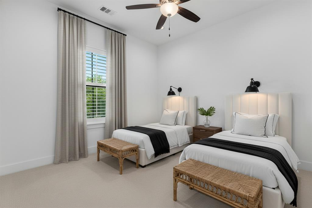 Guest bedroom with twin beds, woven benches and black sconce lighting