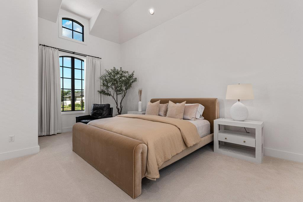 Casita bedroom with vaulted ceiling, arched window and velvet bed