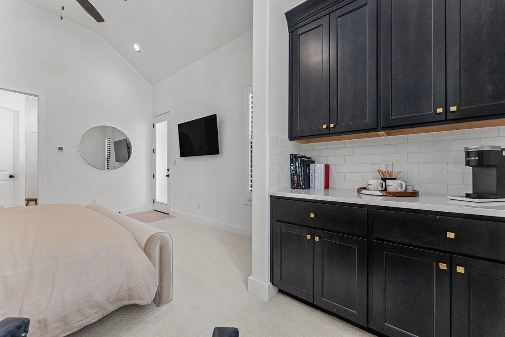Casita bedroom with kitchenette, dark cabinetry and Keurig coffee station